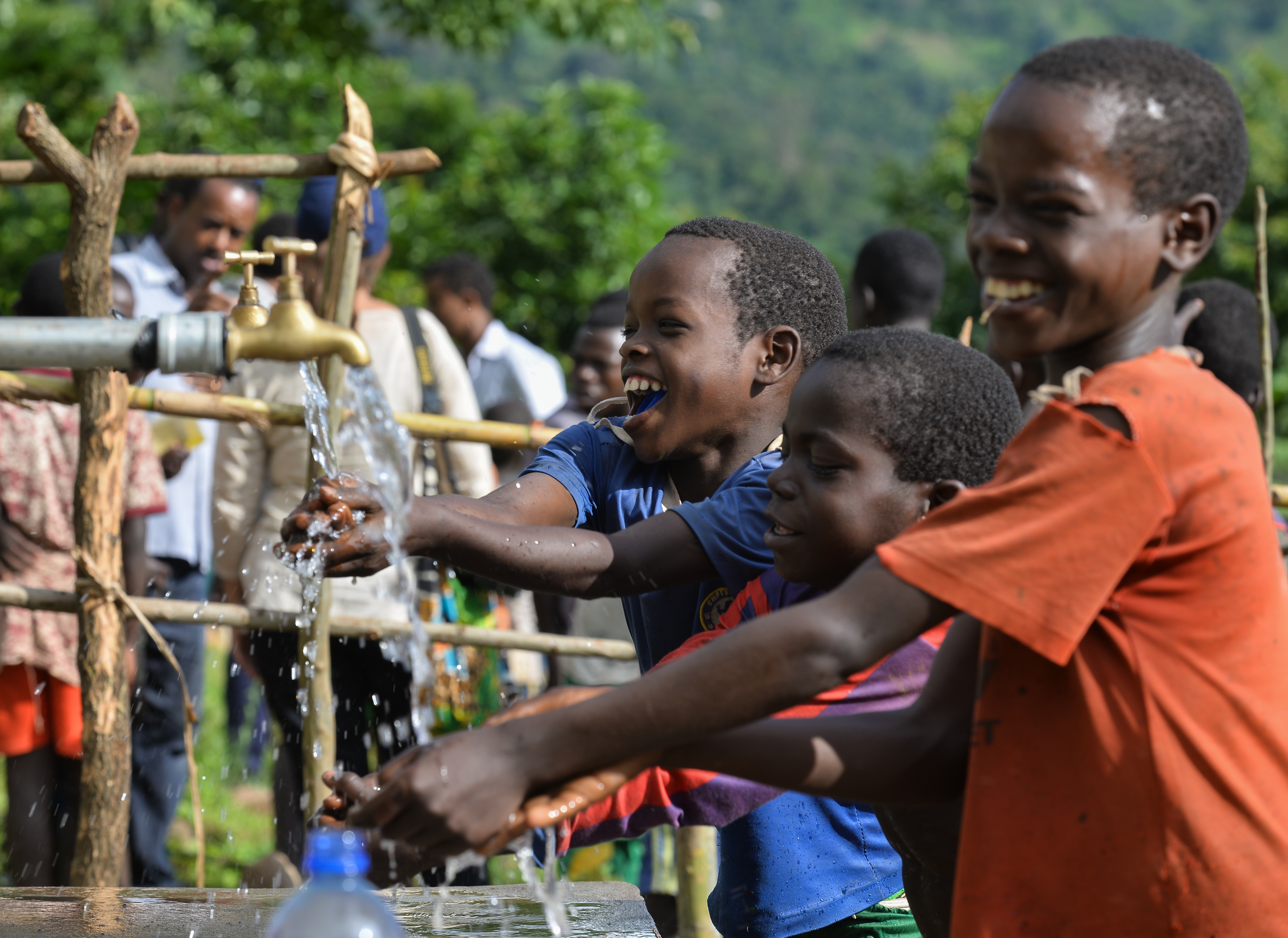 Children enjoy water access for the first time from a hand-pump water system in South Omo, Ethiopia